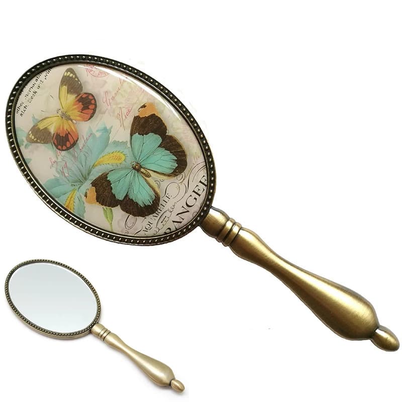 European Vintage Antique Brass Oval 3x4  inches Metal Alloy Framed Glass Hand Mirror with Butterfly Epoxy Decor Back
