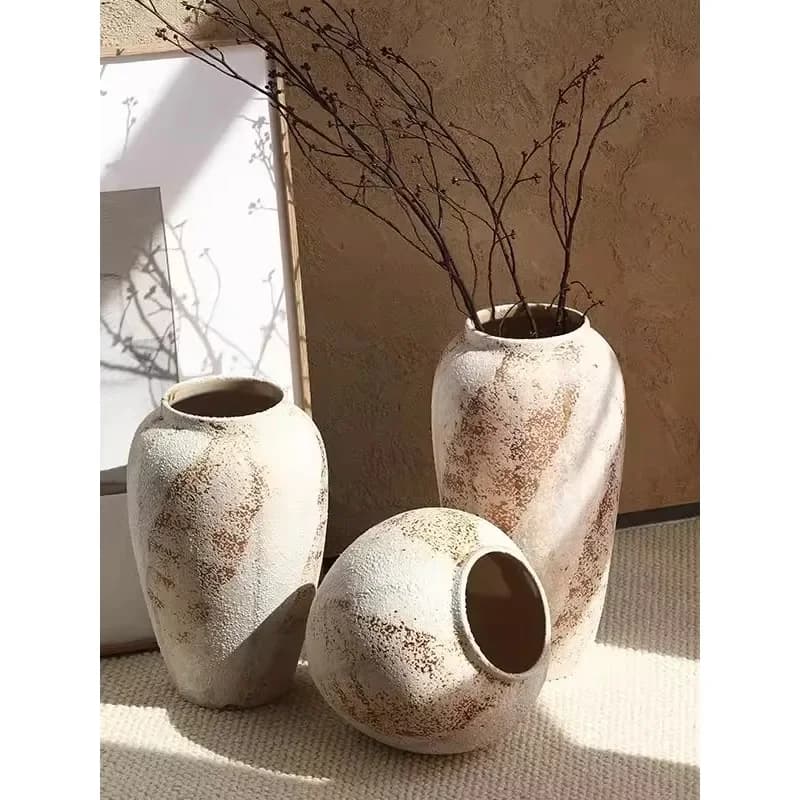 Holly ceramic vase in the entrance, flowers in the living room with coarse pottery