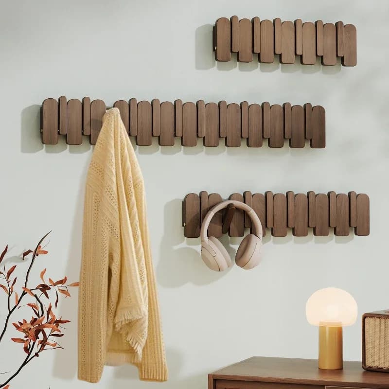 Piano keys on the wall hang a hanger at the entrance to the door, and a solid wood hook coat rack