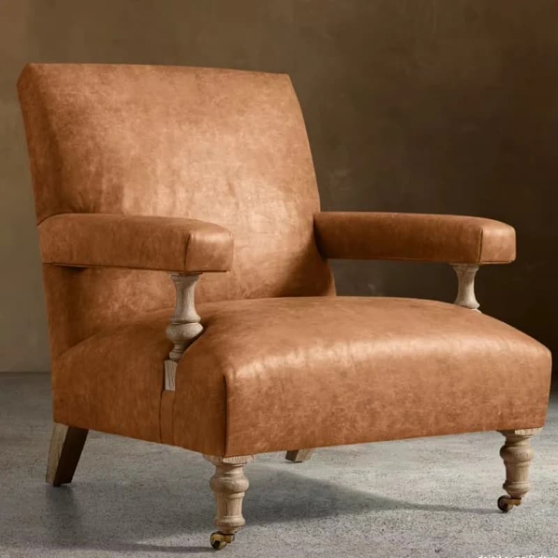 Leather-upholstered armchair with bleached oak legs and brass casters, country-style lounge chair for study villas