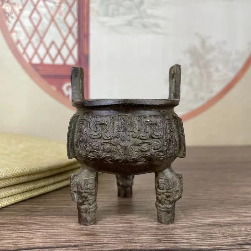 Ancient three-legged bronze cauldron with animal face pattern, Western Zhou period decoration, incense burner with raised ears,
