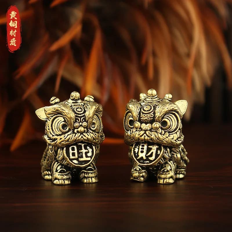 A pair of brass lion figurines, designed to bring good fortune and prosperity, perfect as tea ornaments or decorative pieces for