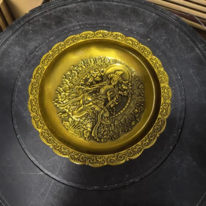 Embossed bronze Guanyin plate made in the Qianlong era, a decorative antique item, featuring a dragon and phoenix motif